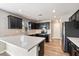 Modern kitchen with dark cabinetry, white countertops, and stainless steel appliances at 15550 N Frank Looyd Wright Blvd # 1057, Scottsdale, AZ 85260