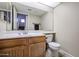 Guest bathroom with wood vanity and toilet at 16644 N 33Rd St # 105, Phoenix, AZ 85032