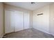 Simple bedroom with carpeted floor and mirrored closet doors at 16644 N 33Rd St # 105, Phoenix, AZ 85032