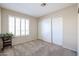 Bedroom with plantation shutters, carpet, and double closet at 16644 N 33Rd St # 105, Phoenix, AZ 85032