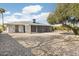 Large backyard with gravel landscaping and screened patio at 17027 N 95Th Dr, Sun City, AZ 85373