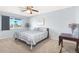 Bright bedroom with striped bedding and ample natural light at 17027 N 95Th Dr, Sun City, AZ 85373