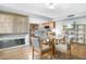 Dining area with glass table, four chairs, and kitchen access at 17027 N 95Th Dr, Sun City, AZ 85373