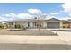 Single-story home with gray exterior, landscaping, and a two-car garage at 17027 N 95Th Dr, Sun City, AZ 85373