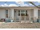 Relaxing front porch with rocking chairs and decorative railing at 17027 N 95Th Dr, Sun City, AZ 85373