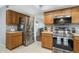 Kitchen boasts stainless steel appliances and wood cabinets at 17027 N 95Th Dr, Sun City, AZ 85373