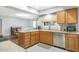 Eat-in kitchen featuring wood cabinets and ample counter space at 17027 N 95Th Dr, Sun City, AZ 85373