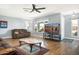 Living room featuring hardwood floors, comfortable seating, and a large TV at 17027 N 95Th Dr, Sun City, AZ 85373