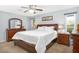 Spacious main bedroom with ceiling fan and wood furniture at 17027 N 95Th Dr, Sun City, AZ 85373