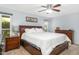 Main bedroom with ceiling fan and ensuite bathroom at 17027 N 95Th Dr, Sun City, AZ 85373