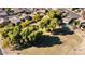 An aerial view of a community featuring lush green spaces and residential homes at 17713 N Larkspur Ln, Surprise, AZ 85374