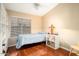 Small bedroom with built-in shelving and hardwood floors at 17713 N Larkspur Ln, Surprise, AZ 85374