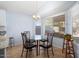 Cozy dining area with glass table and four chairs, near kitchen at 17713 N Larkspur Ln, Surprise, AZ 85374