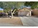 Single-story house with attached garage and mature landscaping at 17713 N Larkspur Ln, Surprise, AZ 85374