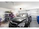 Garage with car, bicycle, and storage shelving at 17713 N Larkspur Ln, Surprise, AZ 85374