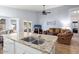 Kitchen island with granite countertop and double sink overlooks living room at 17713 N Larkspur Ln, Surprise, AZ 85374