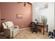 Home office with a desk, chair, and large window with plantation shutters at 17713 N Larkspur Ln, Surprise, AZ 85374