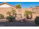 Landscaped backyard with fountain, desert plants, and rock features at 18056 W Buena Vista Dr, Surprise, AZ 85374