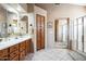 Spacious bathroom with double sinks, wood cabinets, and a separate shower at 18056 W Buena Vista Dr, Surprise, AZ 85374