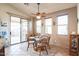 Charming dining area with glass table and sliding door access to patio at 18056 W Buena Vista Dr, Surprise, AZ 85374