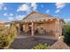 Home exterior showcasing a covered patio and landscaped backyard at 18056 W Buena Vista Dr, Surprise, AZ 85374