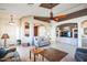 Spacious living room featuring a ceiling fan and built-in entertainment center at 18056 W Buena Vista Dr, Surprise, AZ 85374