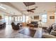 Bright living room with tile floors and a ceiling fan at 18056 W Buena Vista Dr, Surprise, AZ 85374