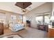 Main bedroom featuring a ceiling fan and large windows at 18056 W Buena Vista Dr, Surprise, AZ 85374