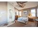 Main bedroom with ensuite bathroom access and ceiling fan at 18056 W Buena Vista Dr, Surprise, AZ 85374