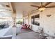 Relaxing covered patio, comfortable seating, and ceiling fan at 18056 W Buena Vista Dr, Surprise, AZ 85374