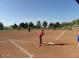 Community softball field with players on a sunny day at 18056 W Buena Vista Dr, Surprise, AZ 85374