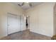 Bedroom with double door closet and tile floor at 18265 N 116Th Dr, Surprise, AZ 85378