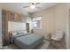 Bright bedroom with built-in cabinets and a comfortable bed at 18265 N 116Th Dr, Surprise, AZ 85378