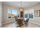 Bright breakfast nook with glass table and wicker chairs and view at 18265 N 116Th Dr, Surprise, AZ 85378