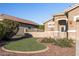 Landscaped front yard with artificial turf and desert landscaping at 18265 N 116Th Dr, Surprise, AZ 85378