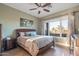 Main bedroom with ceiling fan and large window at 18265 N 116Th Dr, Surprise, AZ 85378