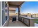 Outdoor kitchen and patio area with built-in grill and seating at 18265 N 116Th Dr, Surprise, AZ 85378