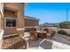 Covered patio with fire pit and seating area at 18265 N 116Th Dr, Surprise, AZ 85378