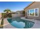 Enjoy this kidney-shaped pool with a large patio at 18265 N 116Th Dr, Surprise, AZ 85378