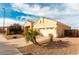 Tan house with a two-car garage and palm trees in front at 1964 S Marble St, Gilbert, AZ 85295