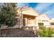 Front view of a tan house with a covered entryway and landscaping at 1964 S Marble St, Gilbert, AZ 85295