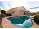 Relaxing kidney-shaped pool and a large backyard with a sunroom at 1964 S Marble St, Gilbert, AZ 85295