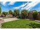 Side yard with gravel landscaping and mature trees at 19919 W Lincoln St, Buckeye, AZ 85326