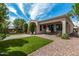 Landscaped backyard with artificial turf and a covered patio at 19919 W Lincoln St, Buckeye, AZ 85326