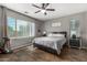 Bright bedroom with gray walls, wood flooring, and ceiling fan at 19919 W Lincoln St, Buckeye, AZ 85326