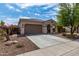 Single story home with attached garage and desert landscaping at 19919 W Lincoln St, Buckeye, AZ 85326