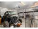 Garage with a side-by-side, shelving, and a dog cage at 19919 W Lincoln St, Buckeye, AZ 85326