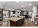 Open concept kitchen with island, dark cabinetry, and stainless steel appliances at 19919 W Lincoln St, Buckeye, AZ 85326