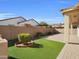 Artificial turf backyard with a paved patio area at 2091 E Geronimo St, Chandler, AZ 85225