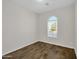 Simple bedroom with dark wood floors and an arched window at 2091 E Geronimo St, Chandler, AZ 85225